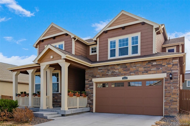 craftsman inspired home featuring a porch and a garage