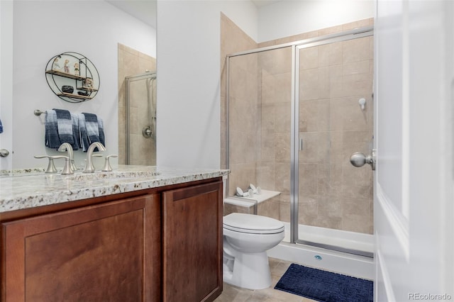 bathroom featuring tile patterned floors, vanity, toilet, and an enclosed shower