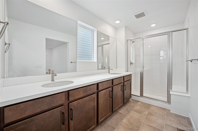 2102 Wagon Wheel Aly, Brighton, CO 80601 - bathroom with double vanity, a stall shower, and recessed lighting