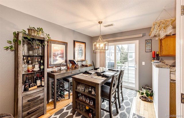 1372 S Cathay Ct Unit 104, Aurora, CO 80017 - dining space with a chandelier and light wood-style flooring