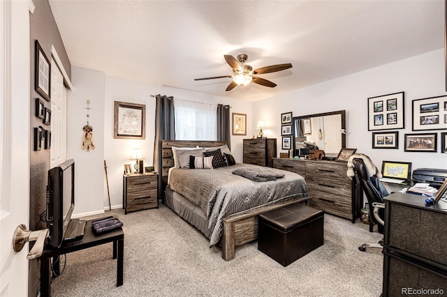 1372 S Cathay Ct Unit 104, Aurora, CO 80017 - bedroom with light carpet, a desk, a ceiling fan, and baseboards