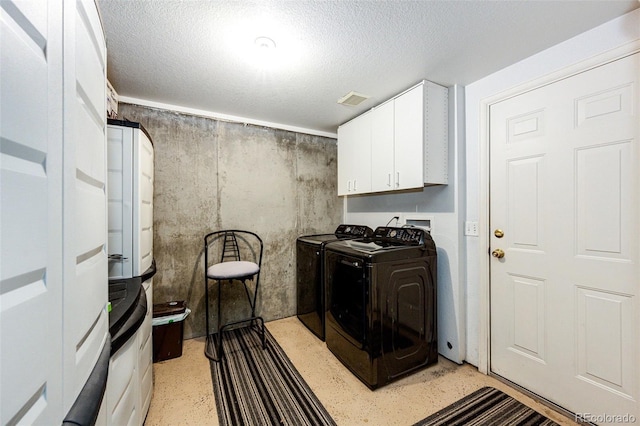 1372 S Cathay Ct Unit 104, Aurora, CO 80017 - laundry room featuring cabinet space, independent washer and dryer, and a textured ceiling