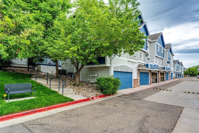 1372 S Cathay Ct Unit 104, Aurora, CO 80017 - view of front of house with a garage, brick siding, and a residential view