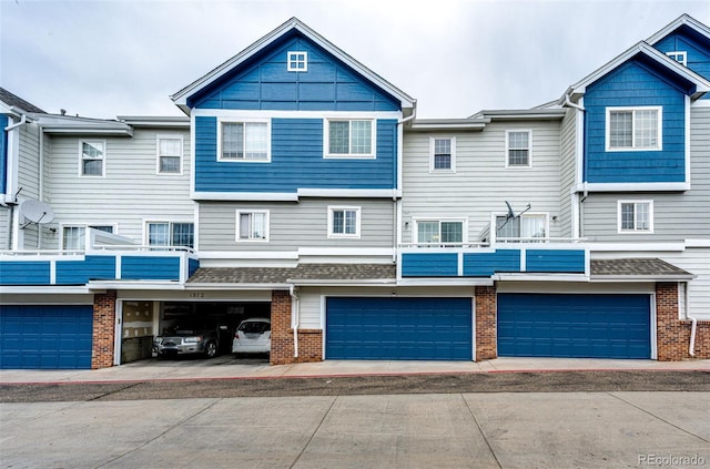 1372 S Cathay Ct Unit 104, Aurora, CO 80017 - back of house with a garage, brick siding, and driveway