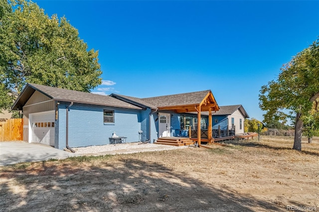 view of front of home with a garage, concrete driveway, and brick siding