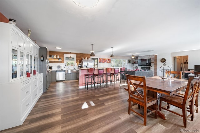 dining space featuring ceiling fan and dark wood-type flooring