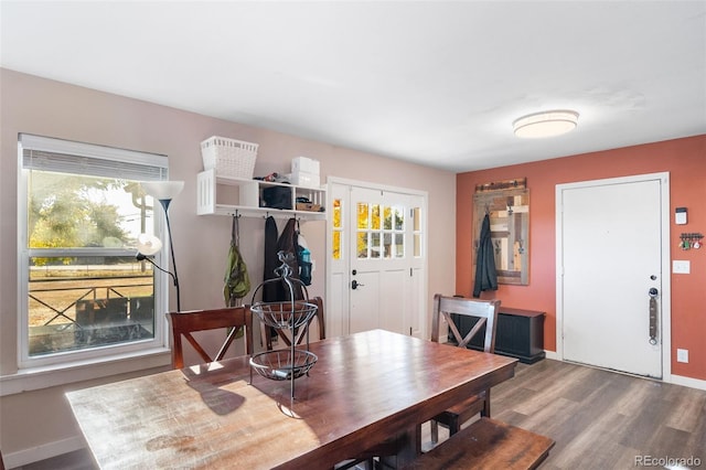 dining space featuring baseboards and wood finished floors