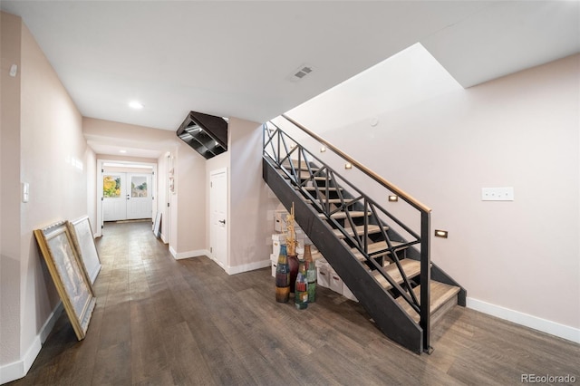 stairway with recessed lighting, wood finished floors, visible vents, and baseboards