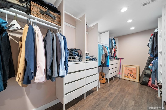 walk in closet with wood finished floors and visible vents