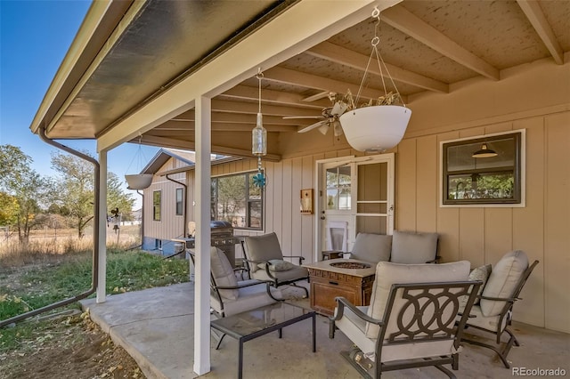 view of patio / terrace with ceiling fan and an outdoor fire pit