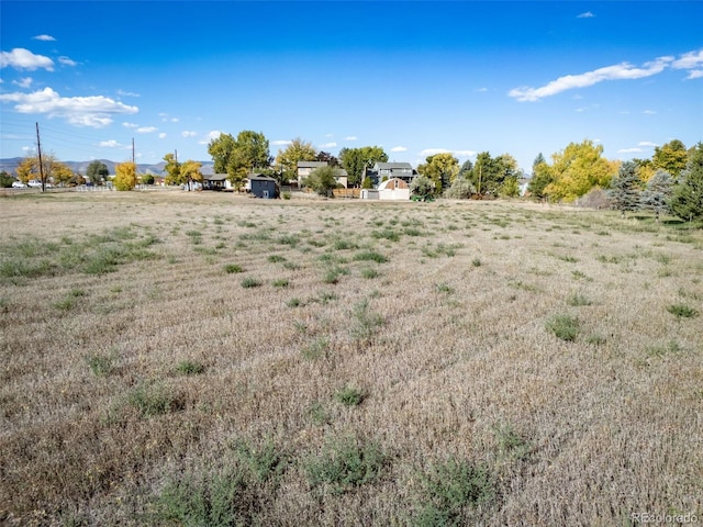 view of yard with a rural view