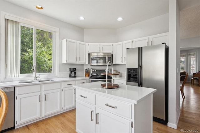 kitchen with light countertops, appliances with stainless steel finishes, and a sink