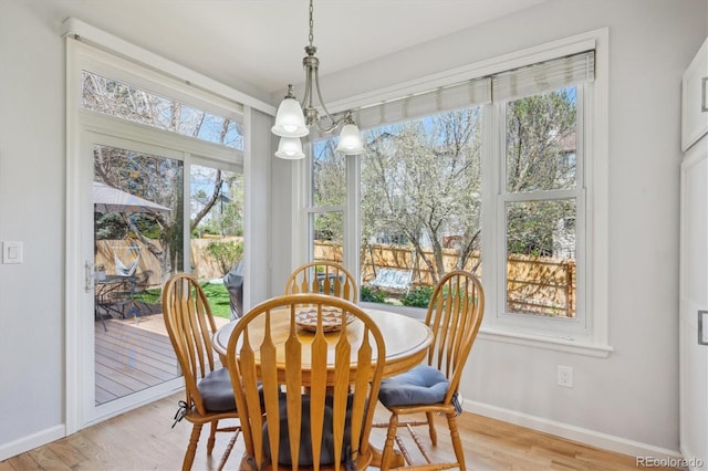 dining area with baseboards and light wood-style floors