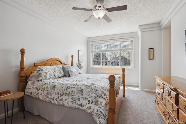 bedroom with carpet floors, baseboards, a ceiling fan, and a textured ceiling