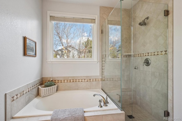 bathroom with a bath and a stall shower