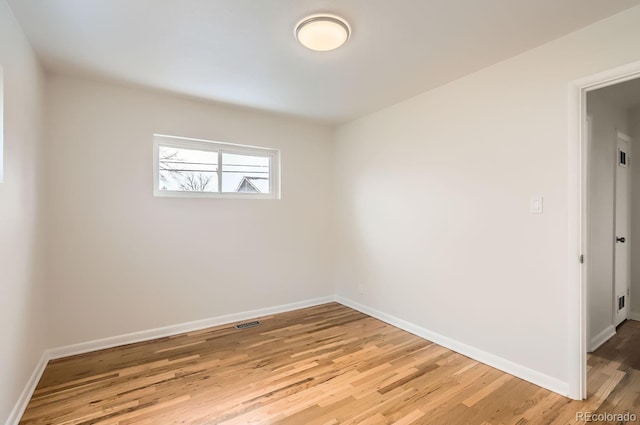 spare room featuring light hardwood / wood-style flooring