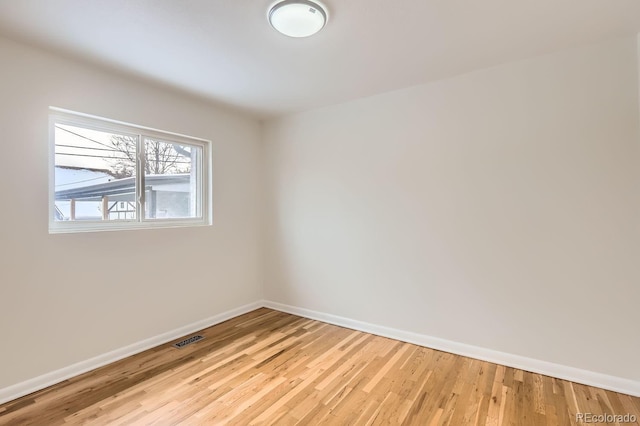 spare room featuring light wood-type flooring