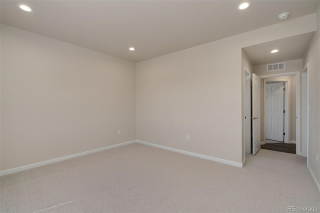 spare room featuring baseboards, light colored carpet, visible vents, and recessed lighting