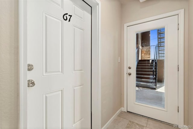 entryway featuring light tile patterned floors and baseboards