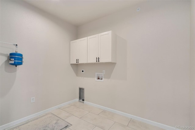 clothes washing area with baseboards, hookup for a washing machine, cabinet space, and hookup for an electric dryer