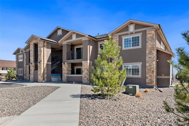 view of front of home with stone siding and stucco siding