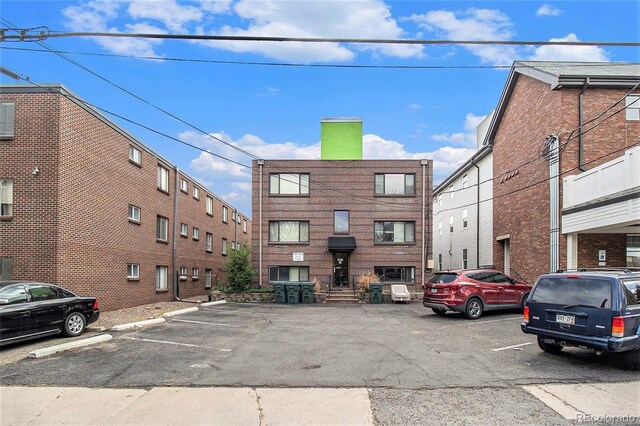 view of property featuring uncovered parking