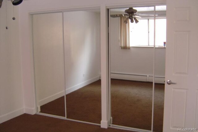 unfurnished bedroom featuring carpet floors, a baseboard radiator, and baseboards