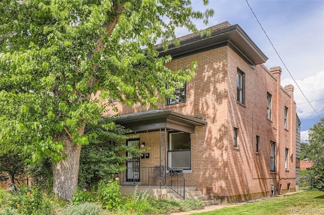 1654 S Pearl St, Denver, CO 80210 - view of home's exterior featuring brick siding