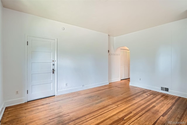 1654 S Pearl St, Denver, CO 80210 - spare room featuring arched walkways and wood-type flooring