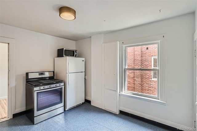 1654 S Pearl St, Denver, CO 80210 - kitchen featuring stainless steel appliances and baseboards