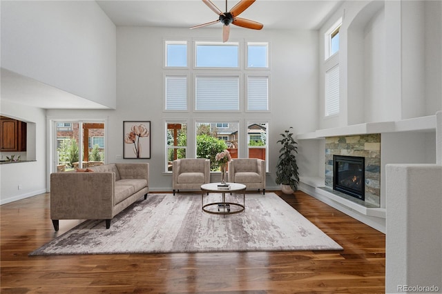 14325 N Santa Fe St, Broomfield, CO 80023 - living room featuring a ceiling fan, a high ceiling, a tile fireplace, and wood finished floors