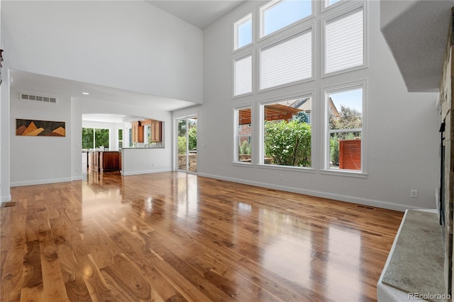 14325 N Santa Fe St, Broomfield, CO 80023 - unfurnished living room featuring wood finished floors and a towering ceiling
