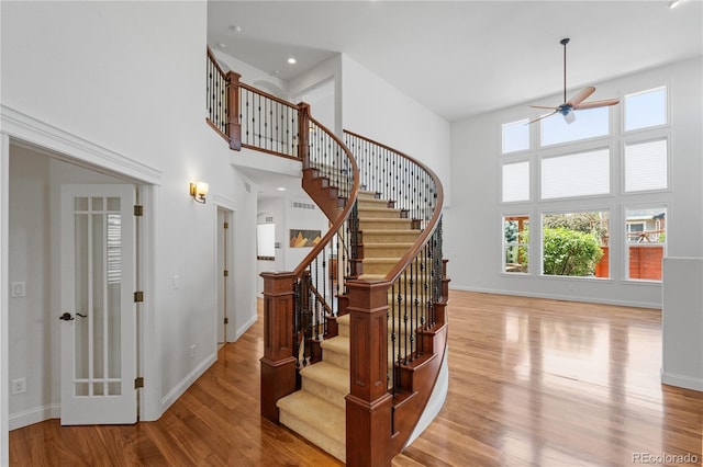 14325 N Santa Fe St, Broomfield, CO 80023 - stairs with a towering ceiling, ceiling fan, wood finished floors, and recessed lighting