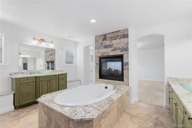 14325 N Santa Fe St, Broomfield, CO 80023 - full bathroom with a fireplace, two vanities, a bath, and ceiling fan