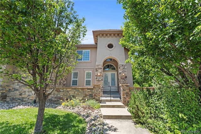 14325 N Santa Fe St, Broomfield, CO 80023 - mediterranean / spanish home featuring stone siding, stucco siding, french doors, and a gate
