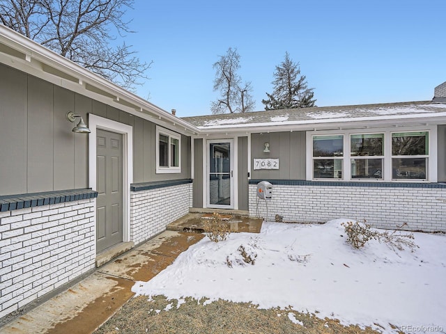 view of snow covered property entrance