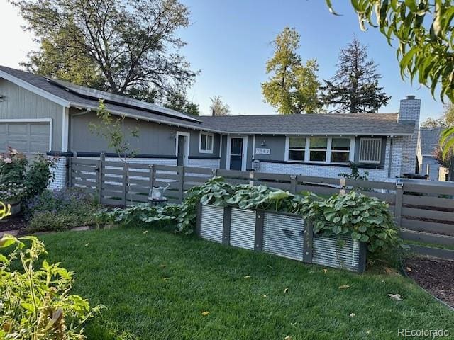 single story home featuring a front yard and a garage