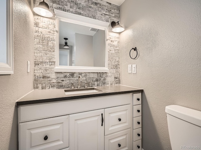 bathroom featuring toilet and vanity