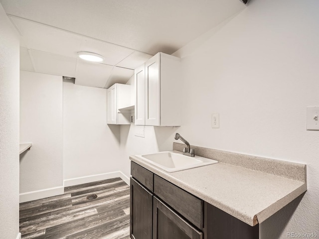 kitchen with white cabinetry, sink, dark hardwood / wood-style flooring, and dark brown cabinetry