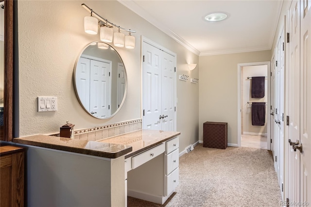 bathroom with crown molding, vanity, and baseboards