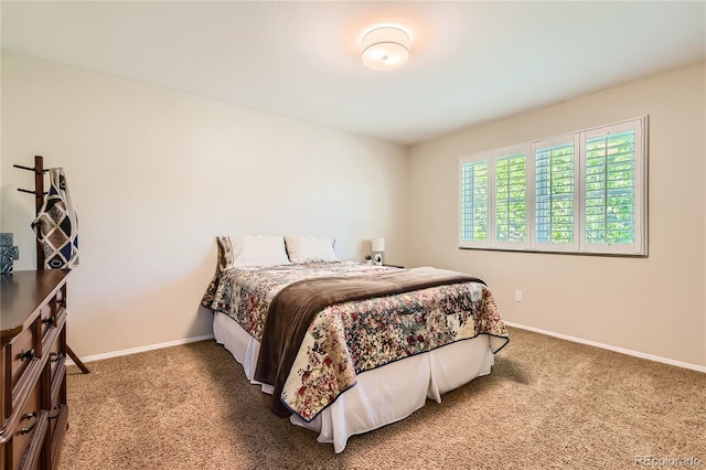bedroom with carpet floors and baseboards