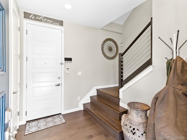 entrance foyer featuring stairs, wood finished floors, baseboards, and recessed lighting