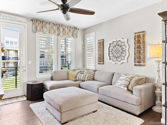 living area with ceiling fan and wood finished floors