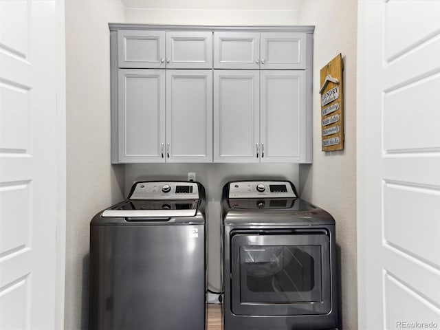 laundry area with cabinet space and washer and clothes dryer