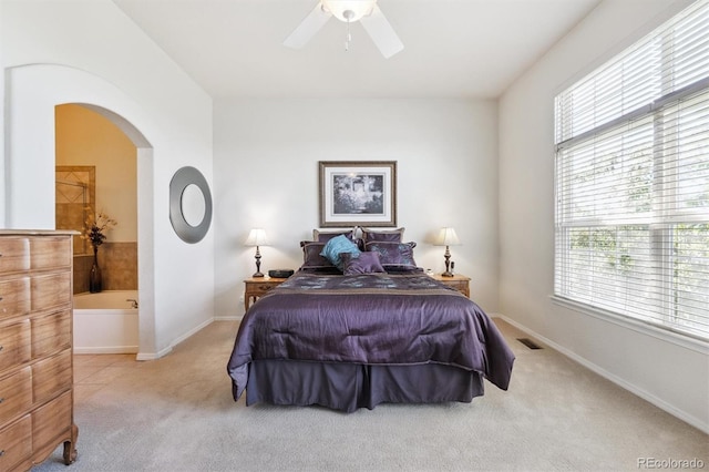 3742 E 127th Ln, Thornton, CO 80241 - bedroom featuring carpet flooring, multiple windows, arched walkways, and ensuite bathroom