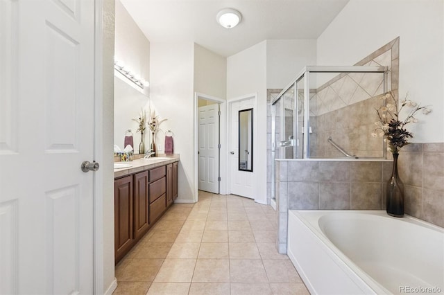 3742 E 127th Ln, Thornton, CO 80241 - bathroom featuring vanity, a bath, a stall shower, and tile patterned floors