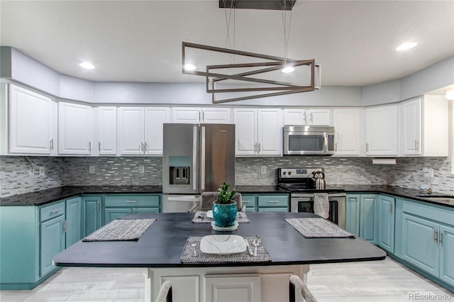 2790 S Wheeling Way, Aurora, CO 80014 - kitchen featuring appliances with stainless steel finishes, dark countertops, white cabinets, blue cabinets, and recessed lighting