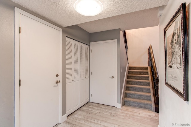 2790 S Wheeling Way, Aurora, CO 80014 - staircase with a textured ceiling and wood finished floors