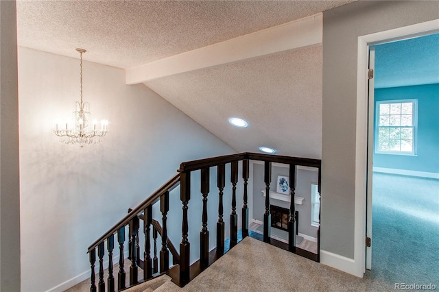2790 S Wheeling Way, Aurora, CO 80014 - stairs featuring a textured ceiling, carpet flooring, a chandelier, and recessed lighting