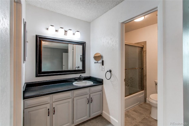 2790 S Wheeling Way, Aurora, CO 80014 - full bathroom featuring vanity, bath / shower combo with glass door, and a textured ceiling